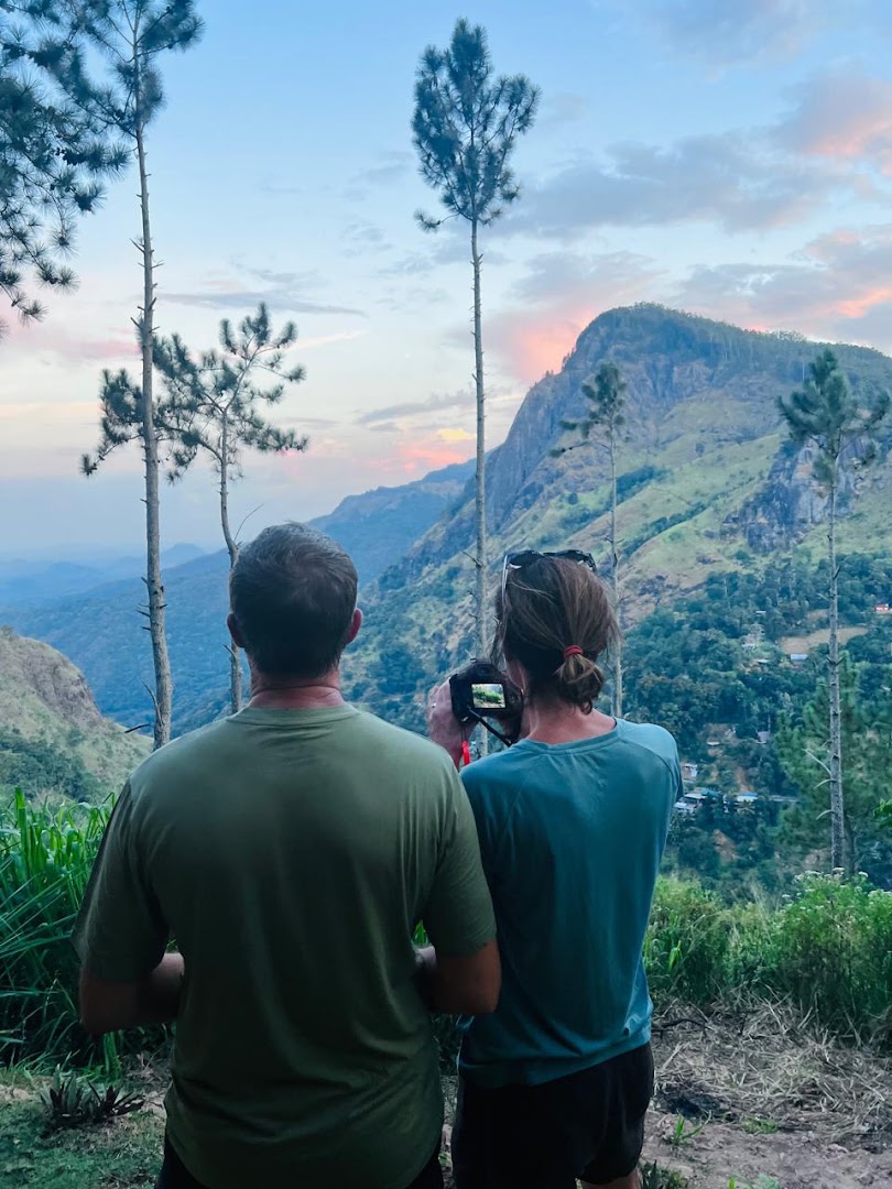 Two visitors watching sunset over Ella Rock